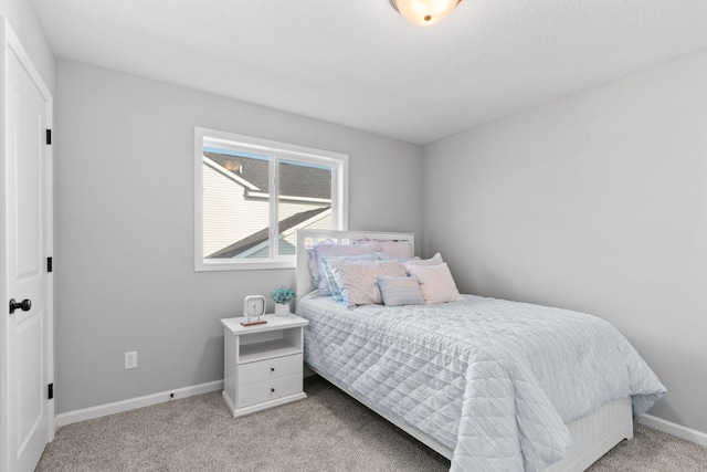 carpeted bedroom featuring baseboards