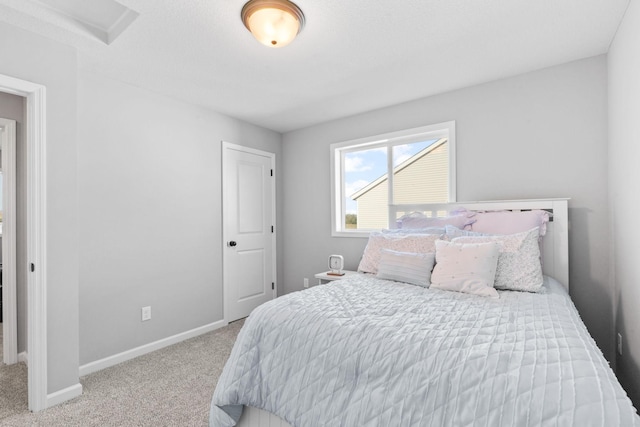 carpeted bedroom featuring baseboards