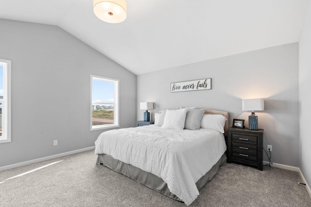 bedroom with lofted ceiling, carpet flooring, and baseboards