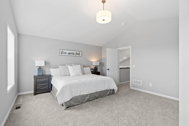 bedroom featuring baseboards, visible vents, vaulted ceiling, and light colored carpet