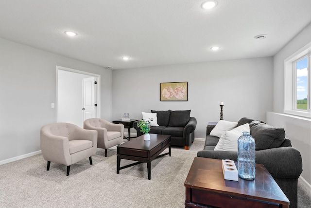 living room with recessed lighting, baseboards, and light colored carpet