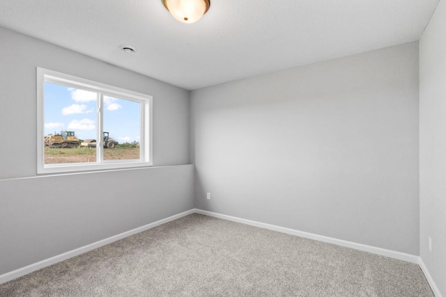 spare room with carpet floors and baseboards