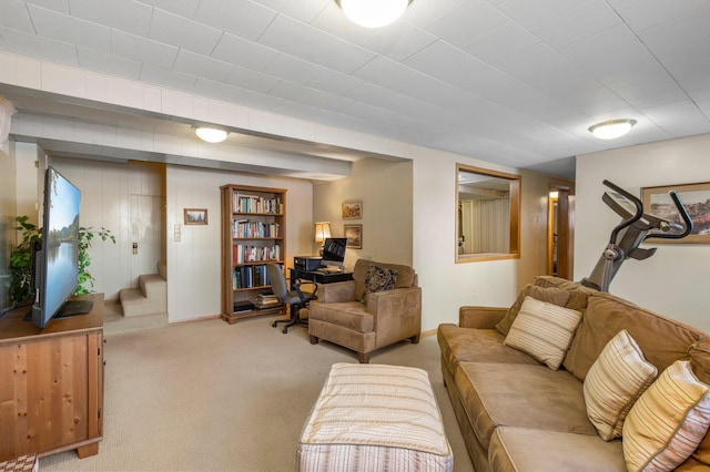 carpeted living area with stairway and baseboards