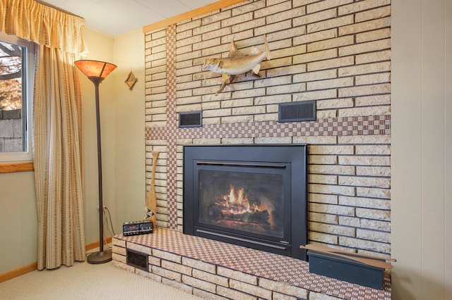 room details featuring carpet flooring, baseboards, and a fireplace