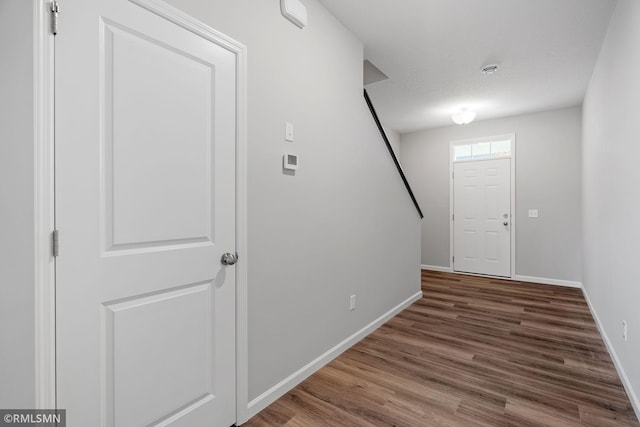 foyer entrance featuring wood finished floors and baseboards