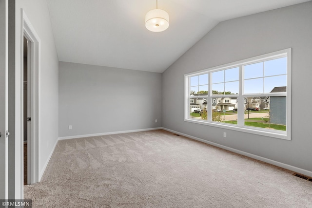 interior space with carpet, visible vents, lofted ceiling, and baseboards