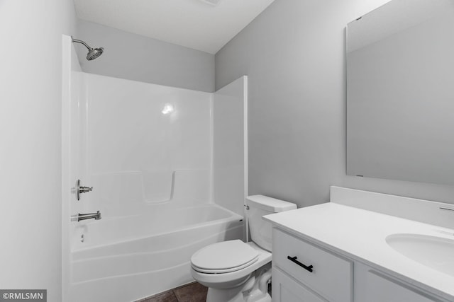 bathroom with toilet, tile patterned flooring,  shower combination, and vanity