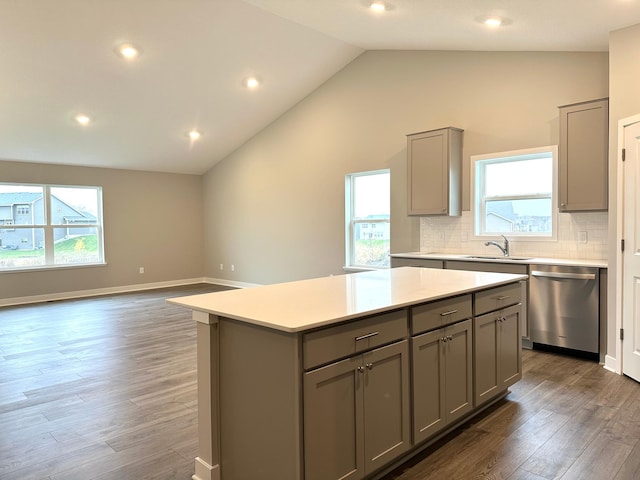 kitchen featuring a sink, light countertops, gray cabinets, a center island, and dishwasher