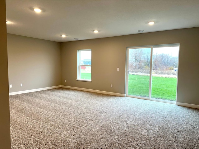 spare room with recessed lighting, carpet, and baseboards