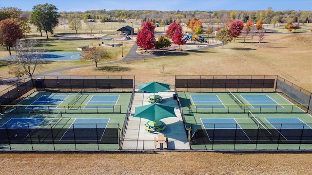 view of tennis court featuring fence