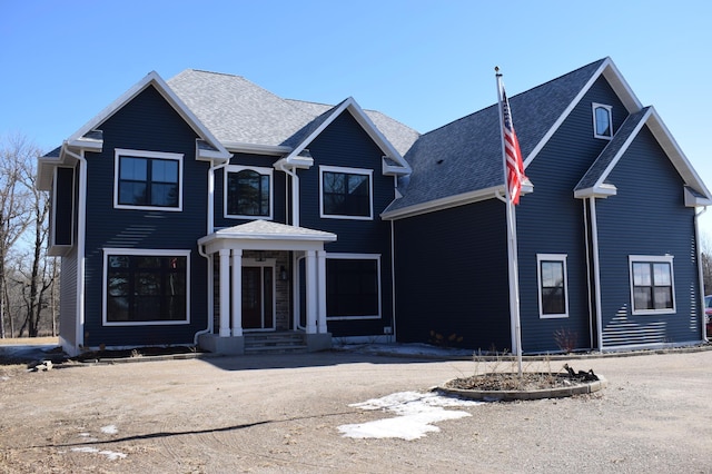 traditional home with roof with shingles