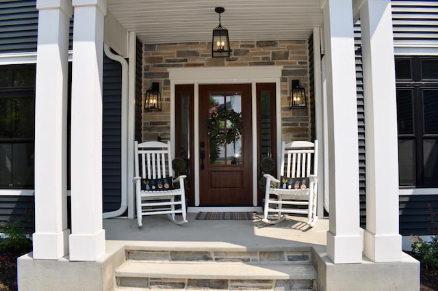 12424 126th Ave NE, Thief River Falls, MN 56701 - doorway to property with stone siding and covered porch