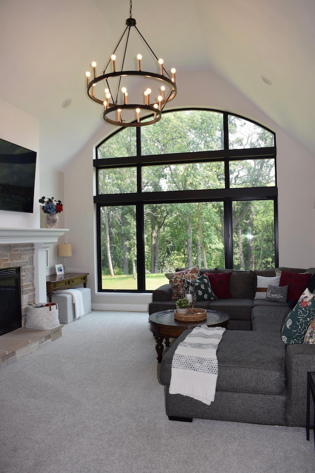12424 126th Ave NE, Thief River Falls, MN 56701 - living room with vaulted ceiling, a chandelier, a stone fireplace, carpet flooring, and plenty of natural light