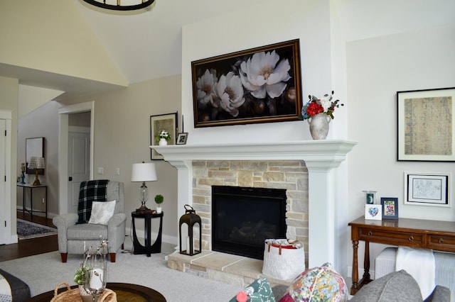 12424 126th Ave NE, Thief River Falls, MN 56701 - living area featuring a stone fireplace, vaulted ceiling, and baseboards