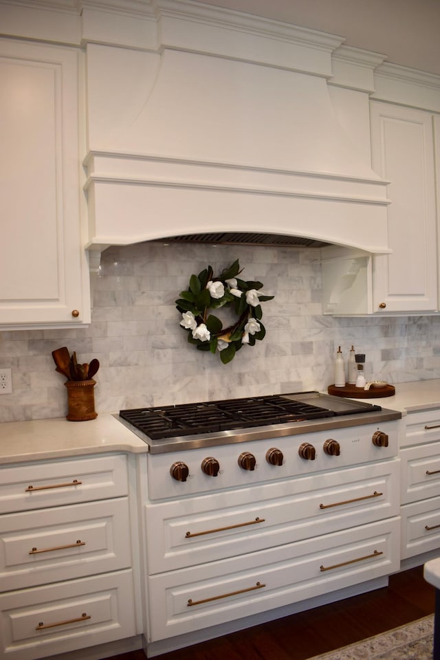 12424 126th Ave NE, Thief River Falls, MN 56701 - kitchen featuring gas stovetop, custom range hood, white cabinetry, and backsplash