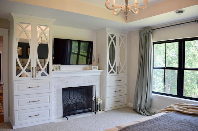 12424 126th Ave NE, Thief River Falls, MN 56701 - bedroom featuring a chandelier, light carpet, multiple windows, and a fireplace