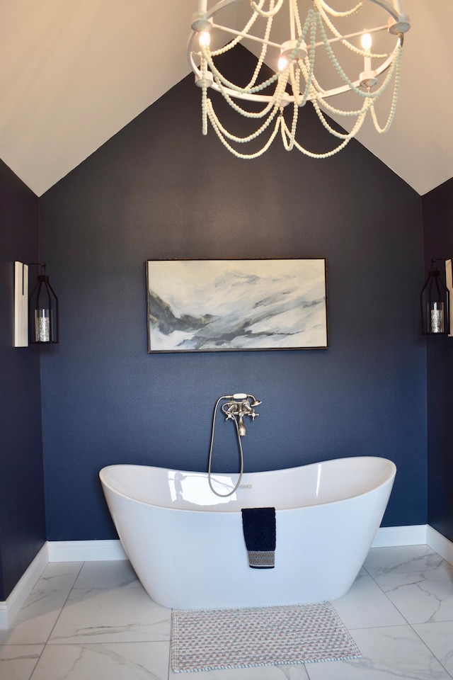 12424 126th Ave NE, Thief River Falls, MN 56701 - bathroom featuring marble finish floors, baseboards, a freestanding tub, a chandelier, and vaulted ceiling