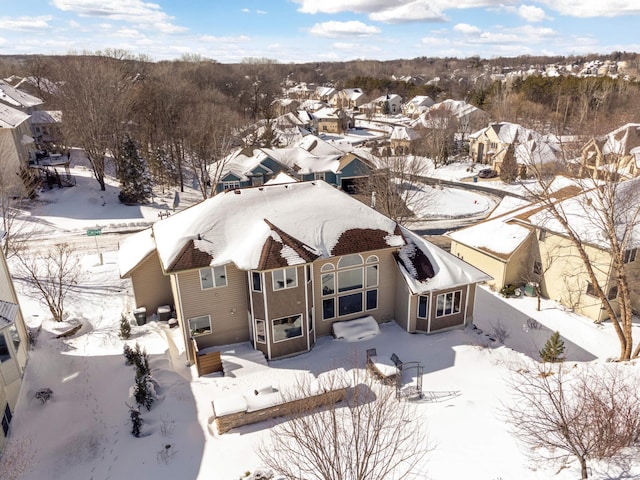 snowy aerial view featuring a residential view