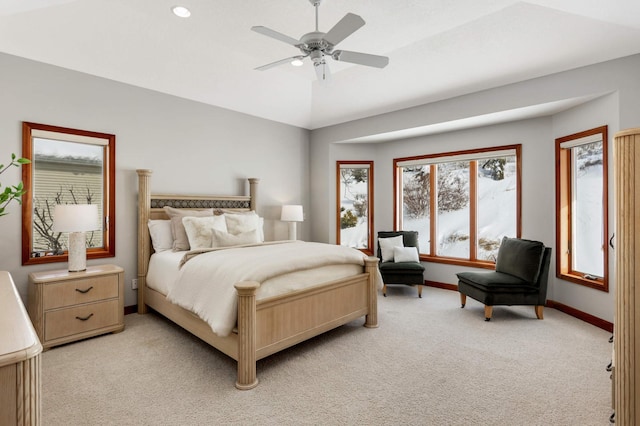 bedroom with a ceiling fan, lofted ceiling, light colored carpet, and baseboards