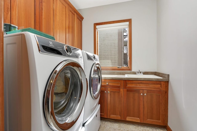 laundry area featuring cabinet space, a sink, and independent washer and dryer