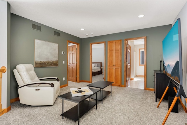 carpeted living room with baseboards and visible vents