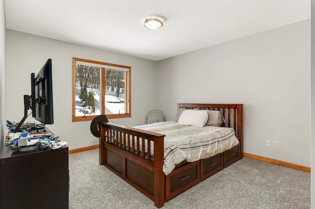 bedroom with light carpet, a textured ceiling, and baseboards