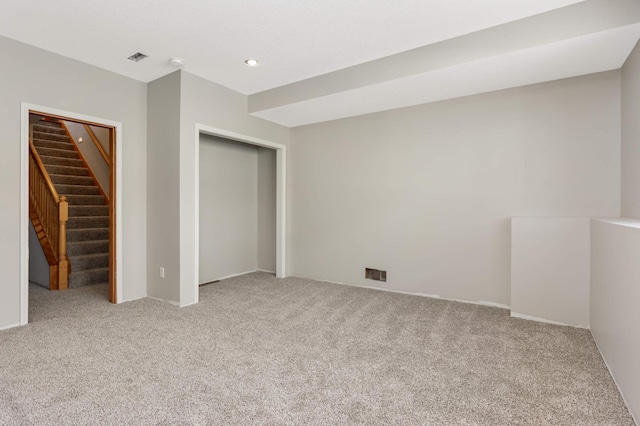 unfurnished bedroom featuring recessed lighting, a closet, light colored carpet, and visible vents