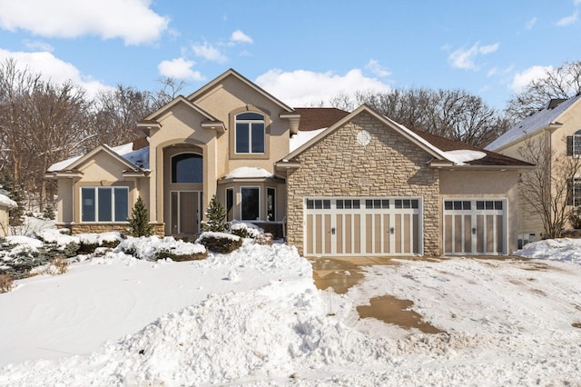 view of front of property featuring a garage, stone siding, and stucco siding