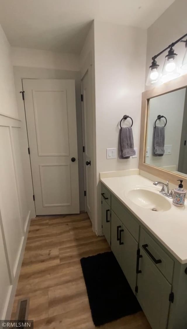 bathroom featuring vanity, wood finished floors, and visible vents