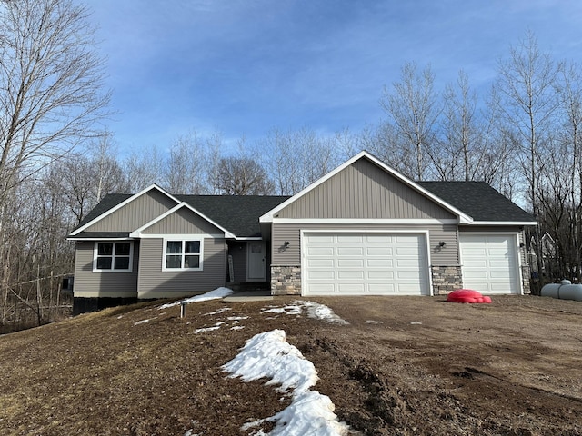 ranch-style house featuring a garage, stone siding, dirt driveway, and a shingled roof