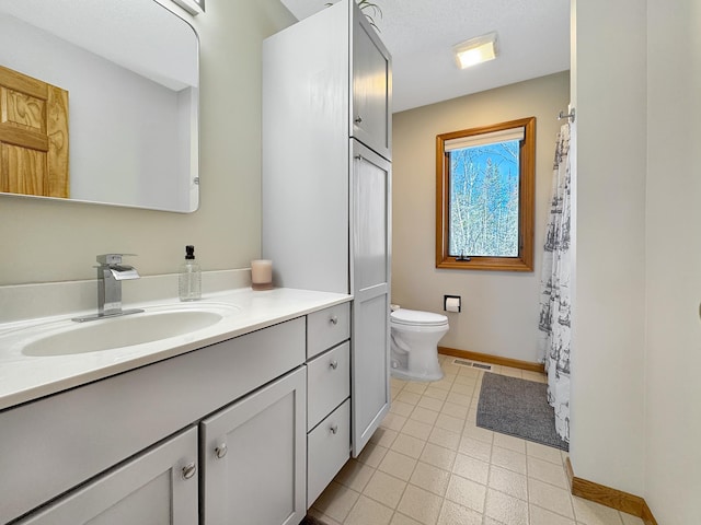 bathroom with toilet, baseboards, visible vents, and vanity