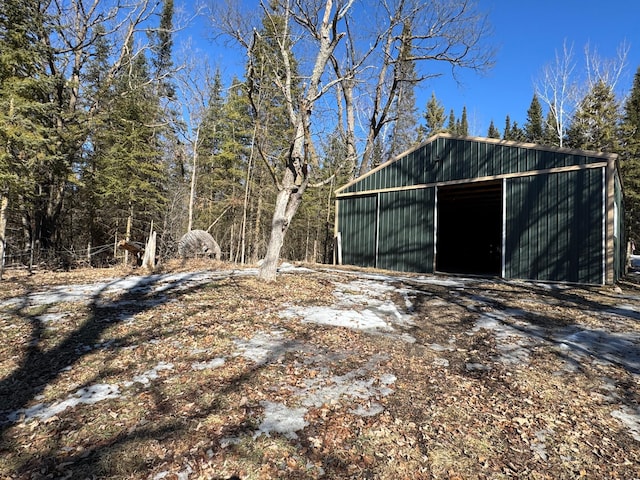 view of yard with a garage, an outbuilding, and an outdoor structure