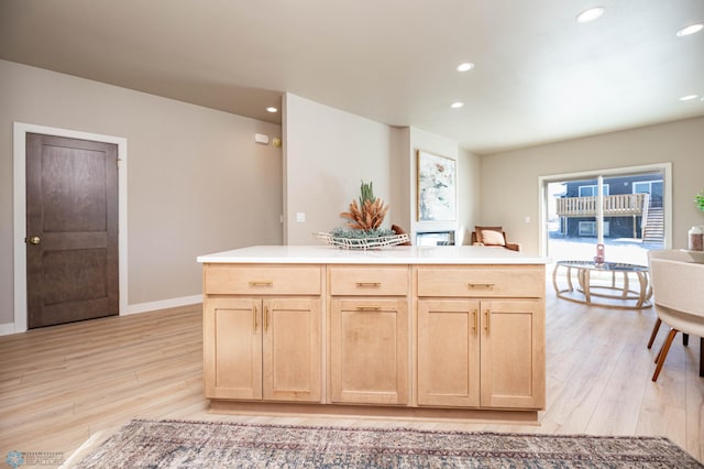 kitchen featuring light wood-style flooring, light brown cabinets, light countertops, and recessed lighting