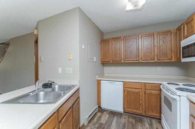 kitchen featuring light countertops, a baseboard heating unit, dark wood-type flooring, a sink, and white appliances