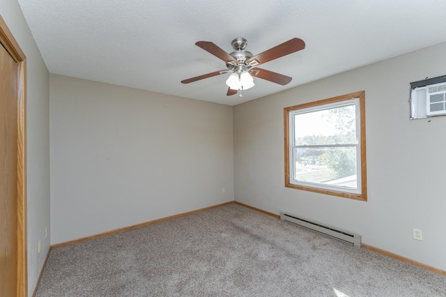 carpeted spare room with a baseboard heating unit, ceiling fan, a textured ceiling, and baseboards