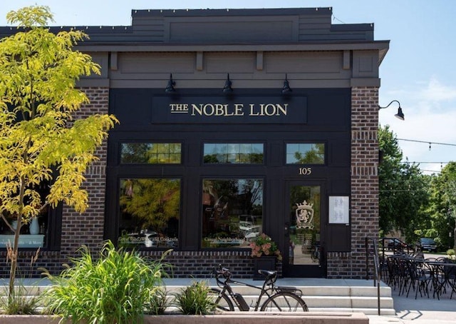 view of exterior entry featuring brick siding