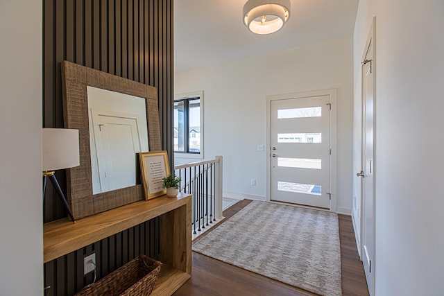entrance foyer with dark wood-style floors and baseboards