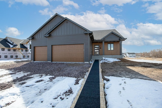 view of front of house featuring a garage, roof with shingles, and board and batten siding