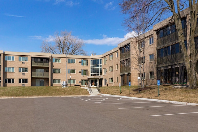 view of building exterior featuring uncovered parking