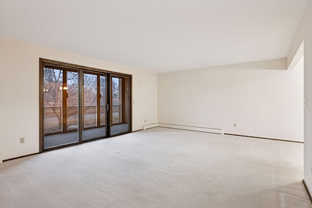 carpeted spare room featuring baseboards and baseboard heating