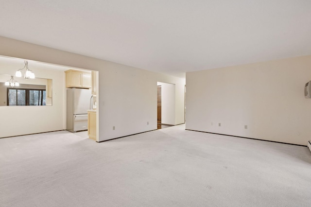 empty room with a chandelier and light colored carpet