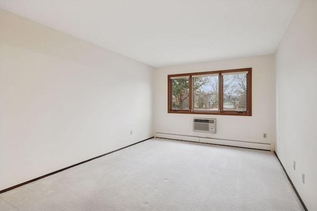 empty room featuring a baseboard radiator, a wall unit AC, and carpet flooring