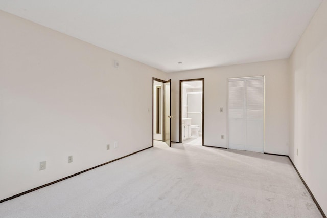 unfurnished room with light carpet and baseboards