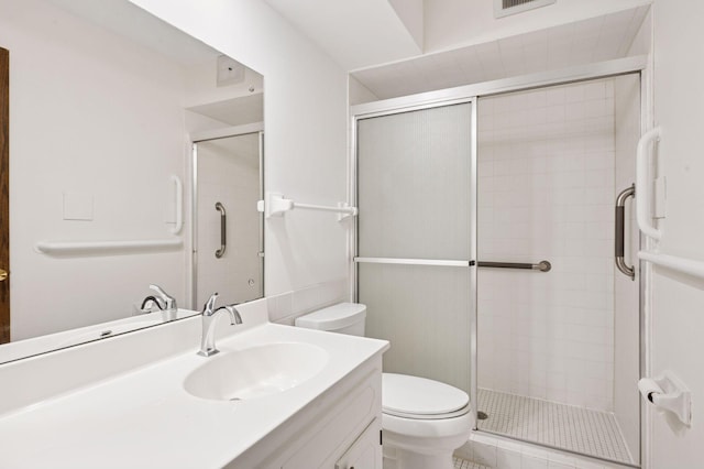 full bathroom featuring toilet, a shower stall, and vanity