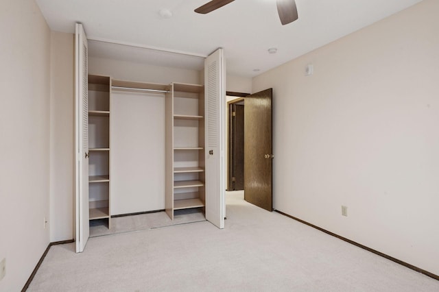 unfurnished bedroom with carpet floors, ceiling fan, baseboards, and a closet