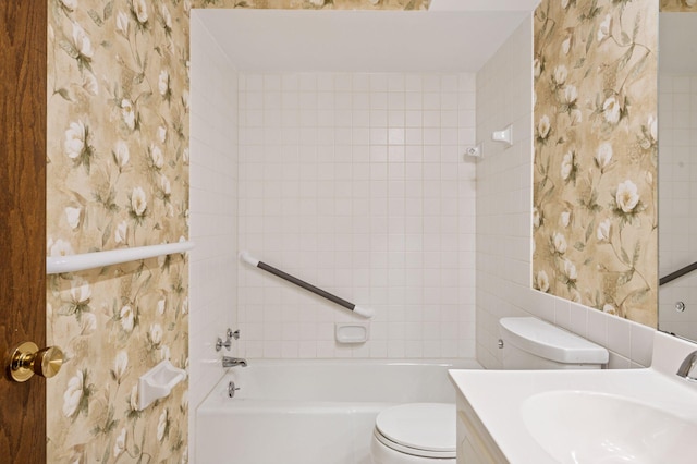 bathroom with toilet, wallpapered walls, a tub, and vanity