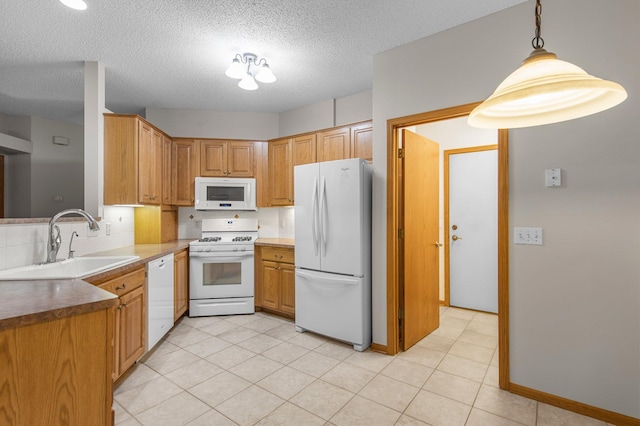 kitchen with hanging light fixtures, decorative backsplash, a sink, a textured ceiling, and white appliances