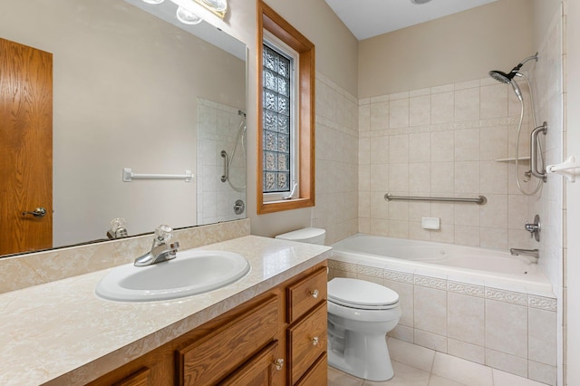 full bathroom with tile patterned flooring, tiled shower / bath combo, vanity, and toilet