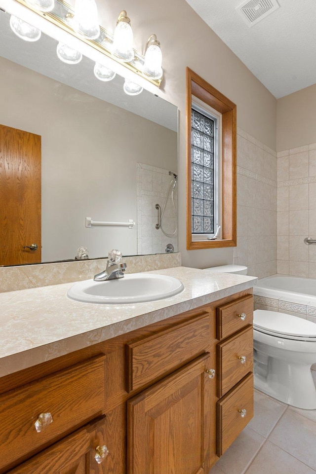 bathroom featuring visible vents, vanity, tile patterned flooring, and toilet