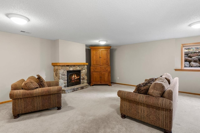 living area featuring light colored carpet, a fireplace, visible vents, and baseboards